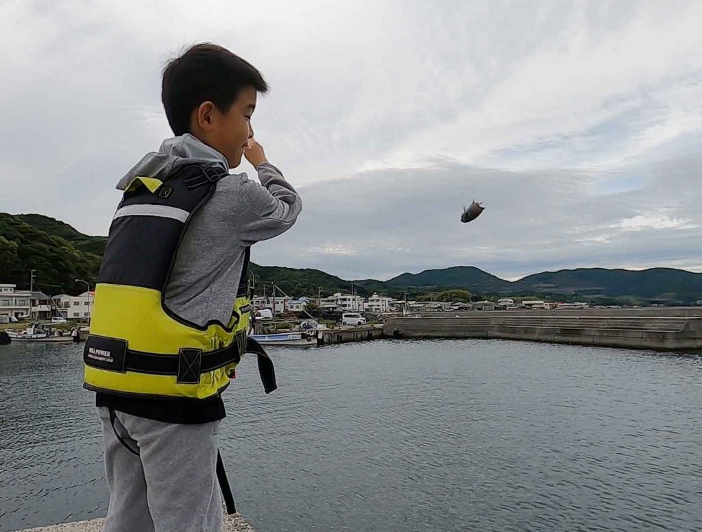 魚を投げる息子